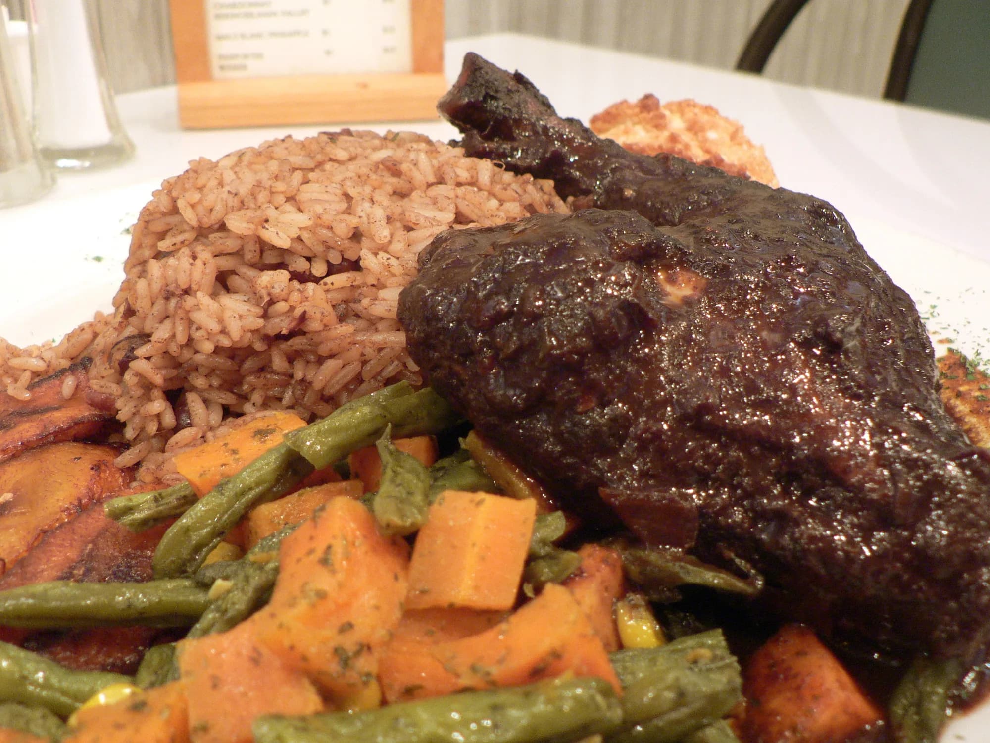 Representative imagery for Greengos Caribbean Cantina: a plated Caribbean meal. Not a photograph of this listing.