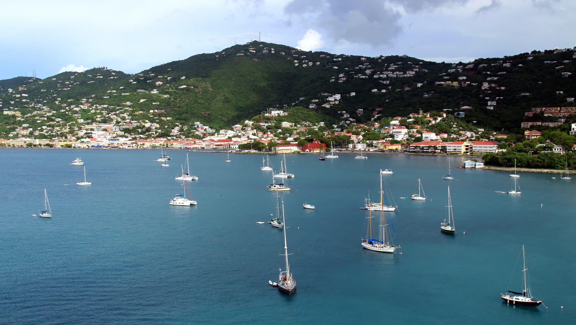 Representative imagery for The Pink Palm Hotel: the Charlotte Amalie shoreline on St. Thomas. Not a photograph of this listing.