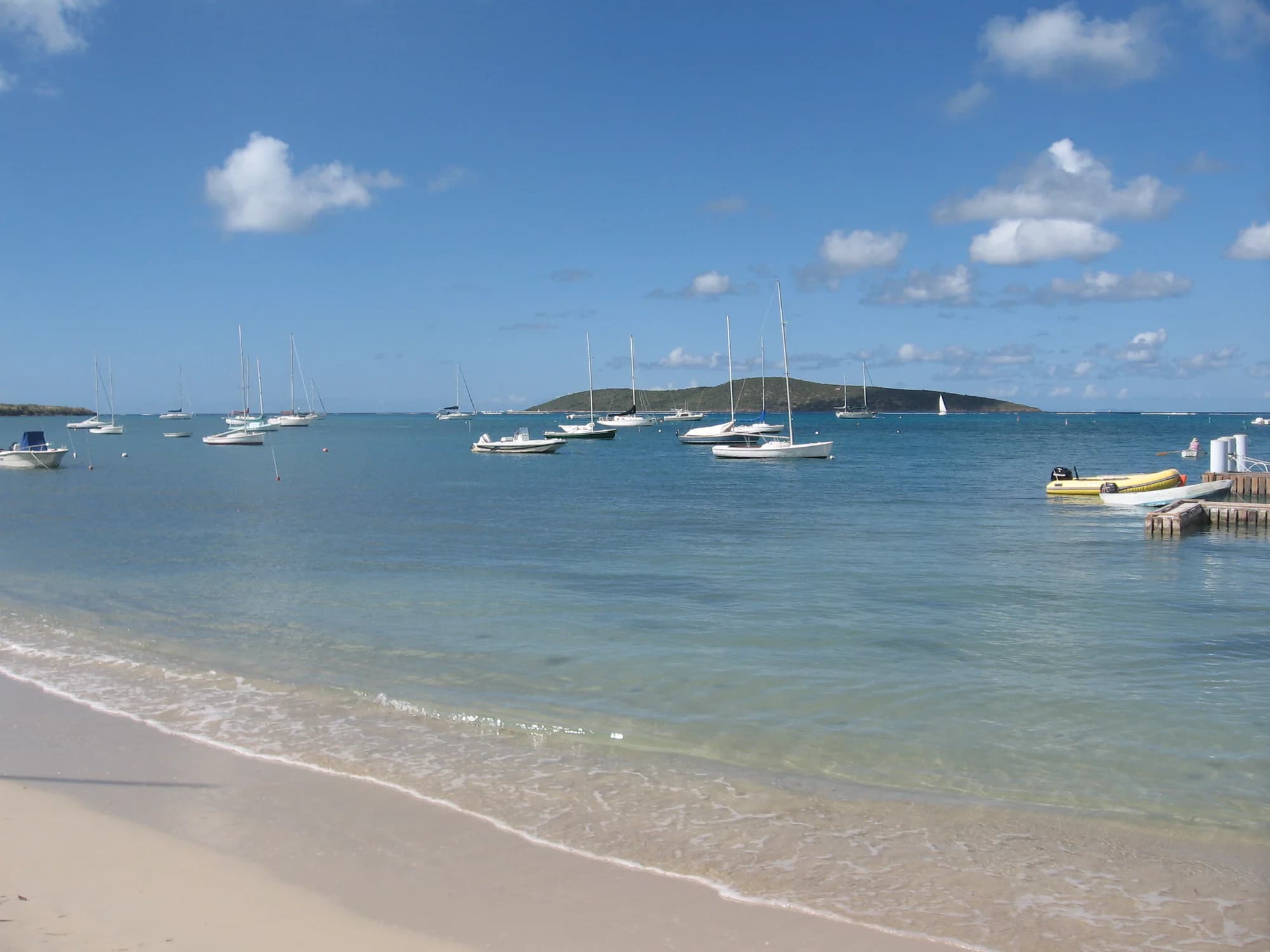Representative imagery for Carina Bay All-Inclusive Resort & Casino: a calm St. Croix shoreline with moored sailboats. Not a photograph of this listing.