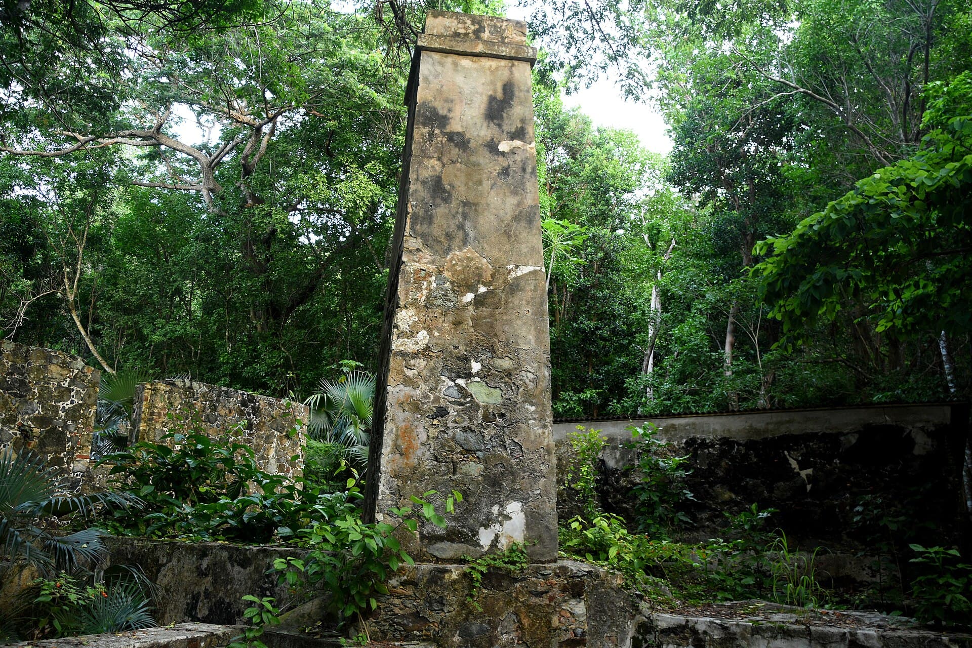 The stone factory chimney at the Cinnamon Bay plantation ruins in the forest on St. John.