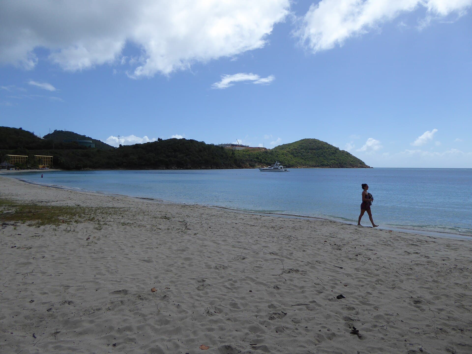 The sweep of sand at Lindbergh Bay Beach curving toward green headlands on St. Thomas.
