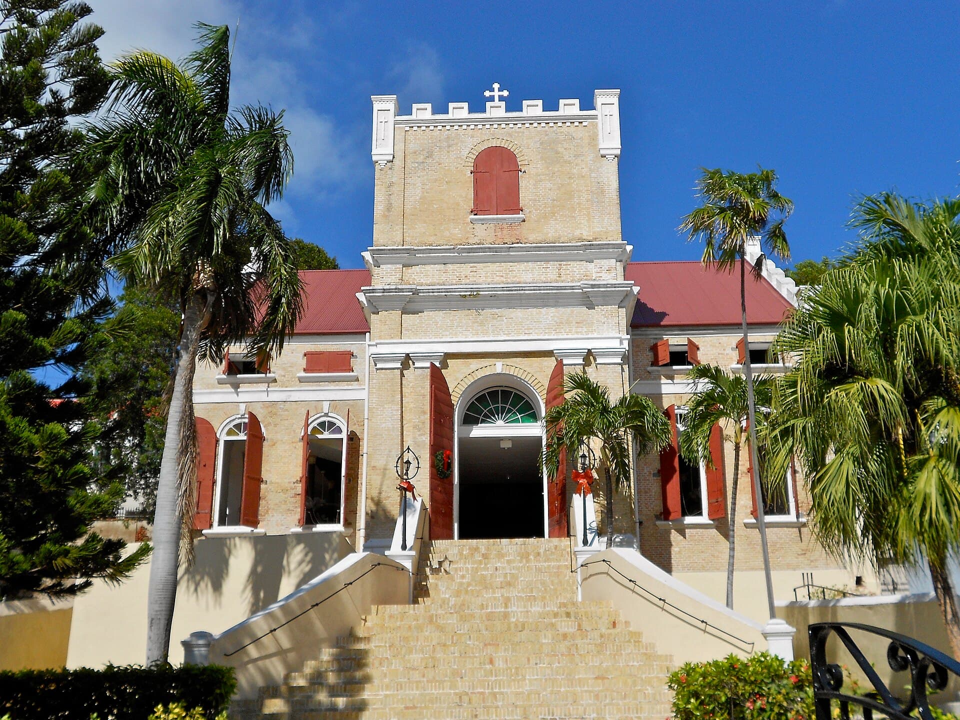 The yellow-brick facade and grand staircase of Frederick Evangelical Lutheran Church in Charlotte Amalie.