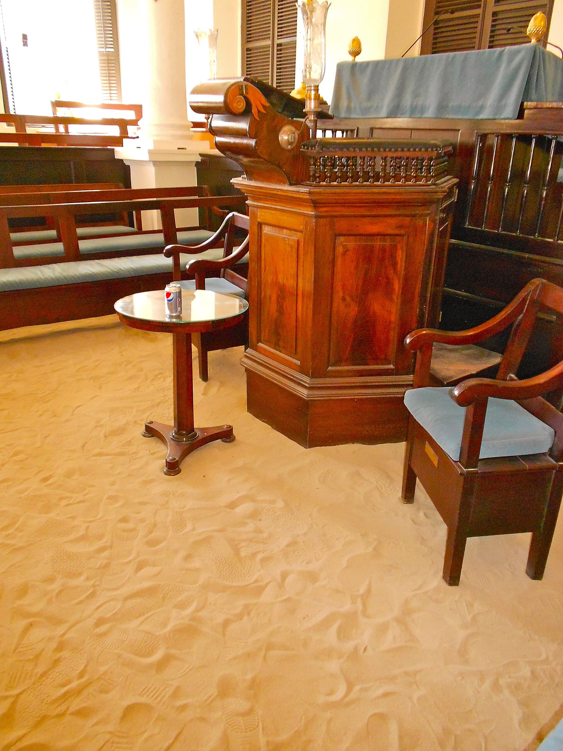 The sand floor and mahogany interior of the St. Thomas Synagogue.