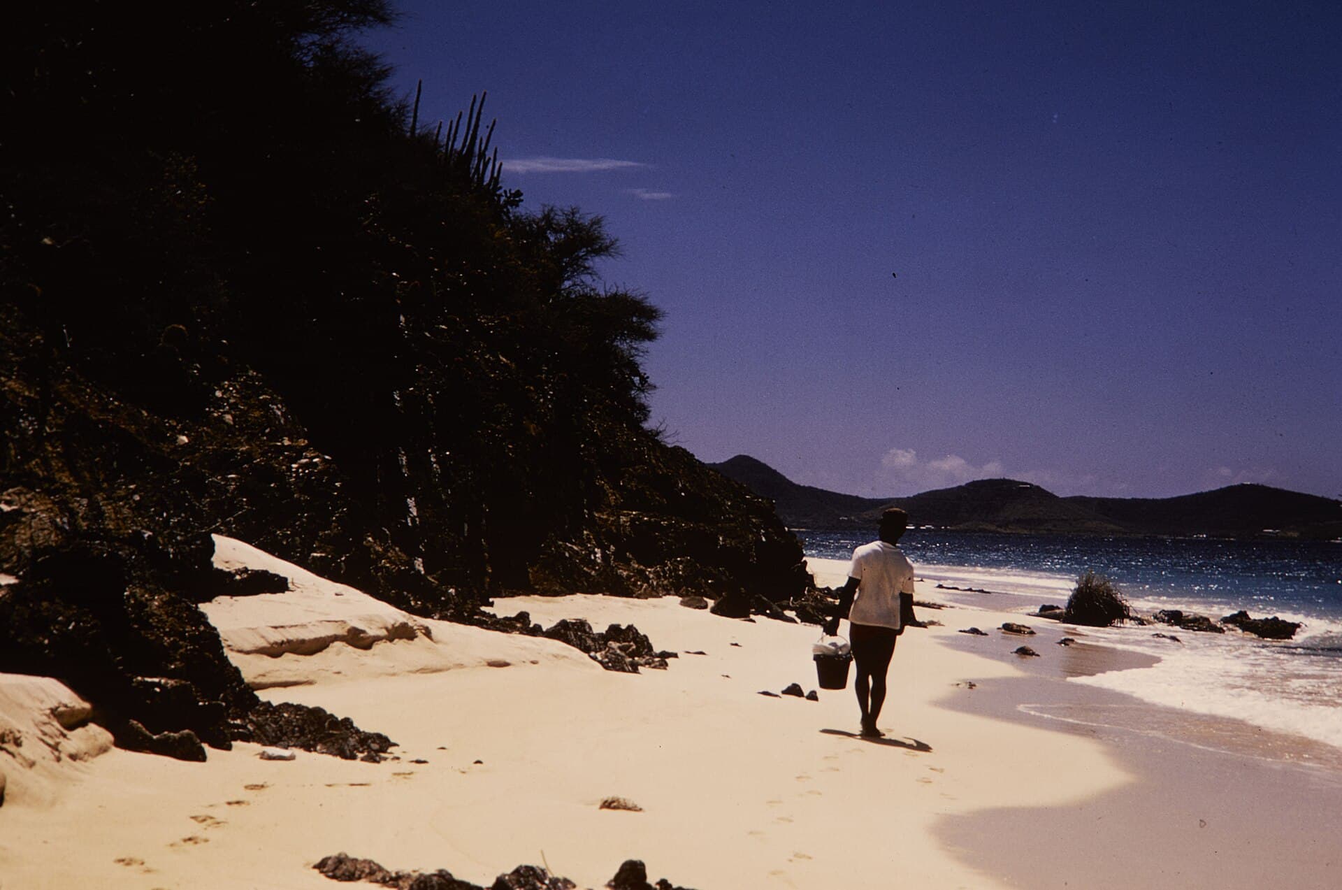 A visitor walking the white-sand beach at Buck Island Reef National Monument off St. Croix.