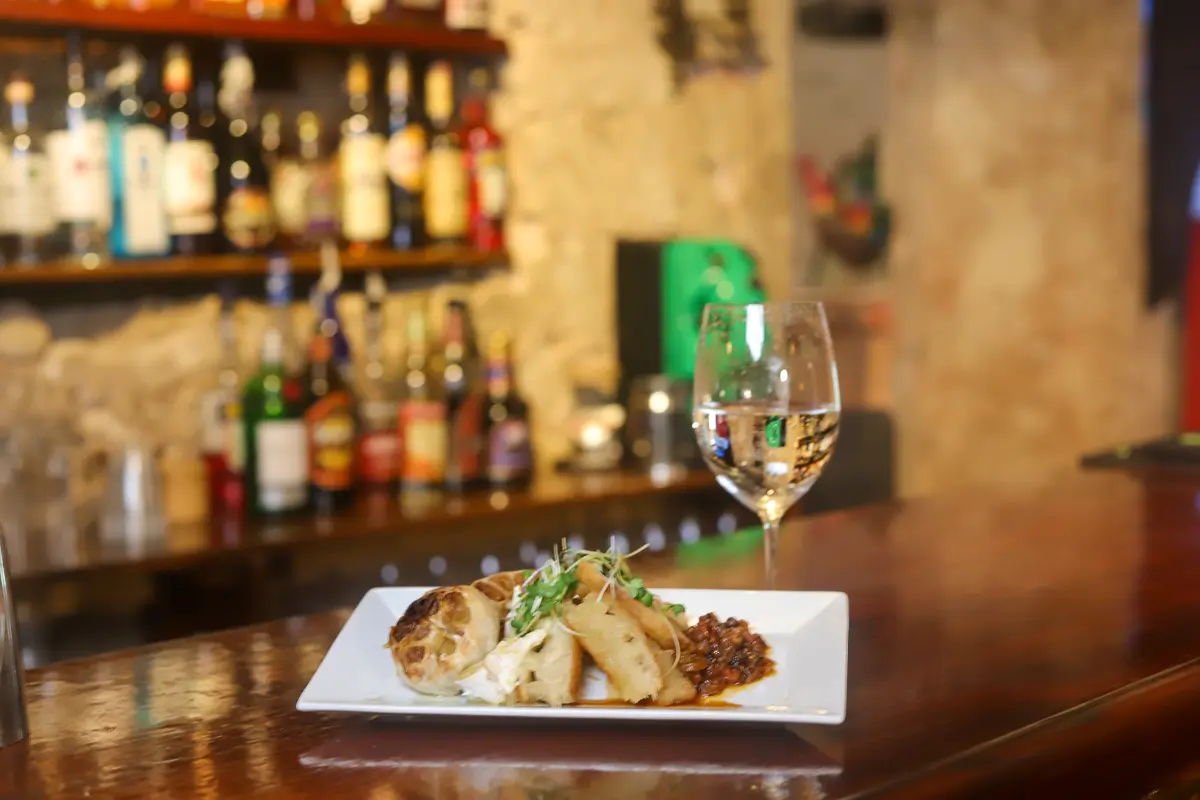 A plated dish and wine glass at the historic 1756 Grotto bar in Christiansted, St. Croix.