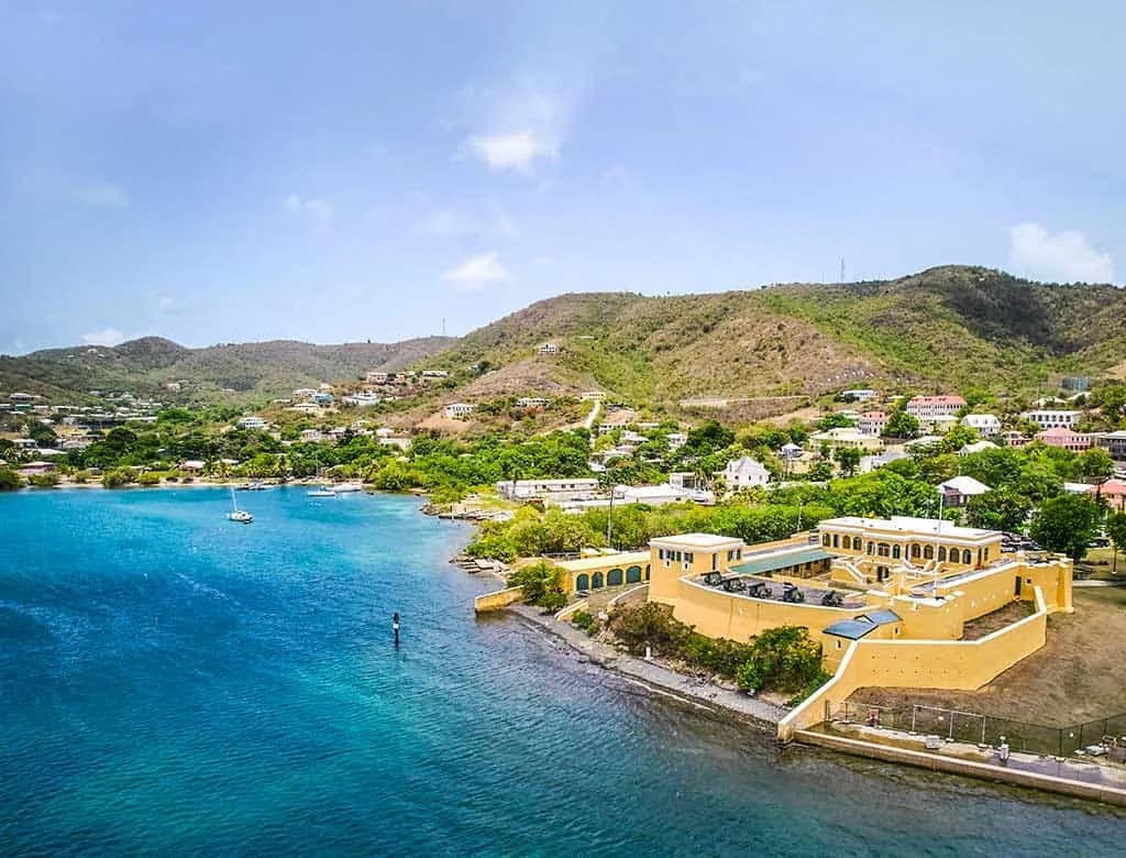 Christiansted National Historic Site in St. Croix beside the harbor under bright blue sky