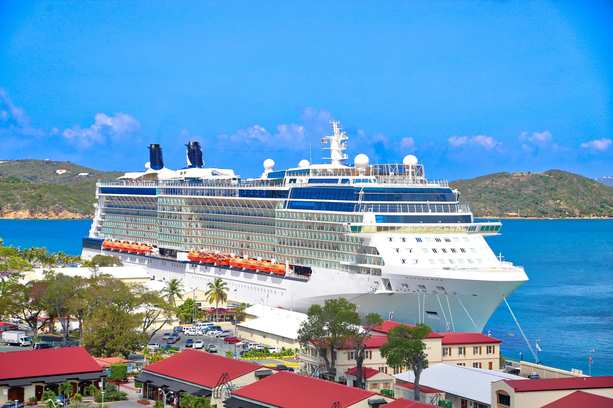 Cruise ship docked at the Havensight pier on St. Thomas beside red-roofed dockside buildings