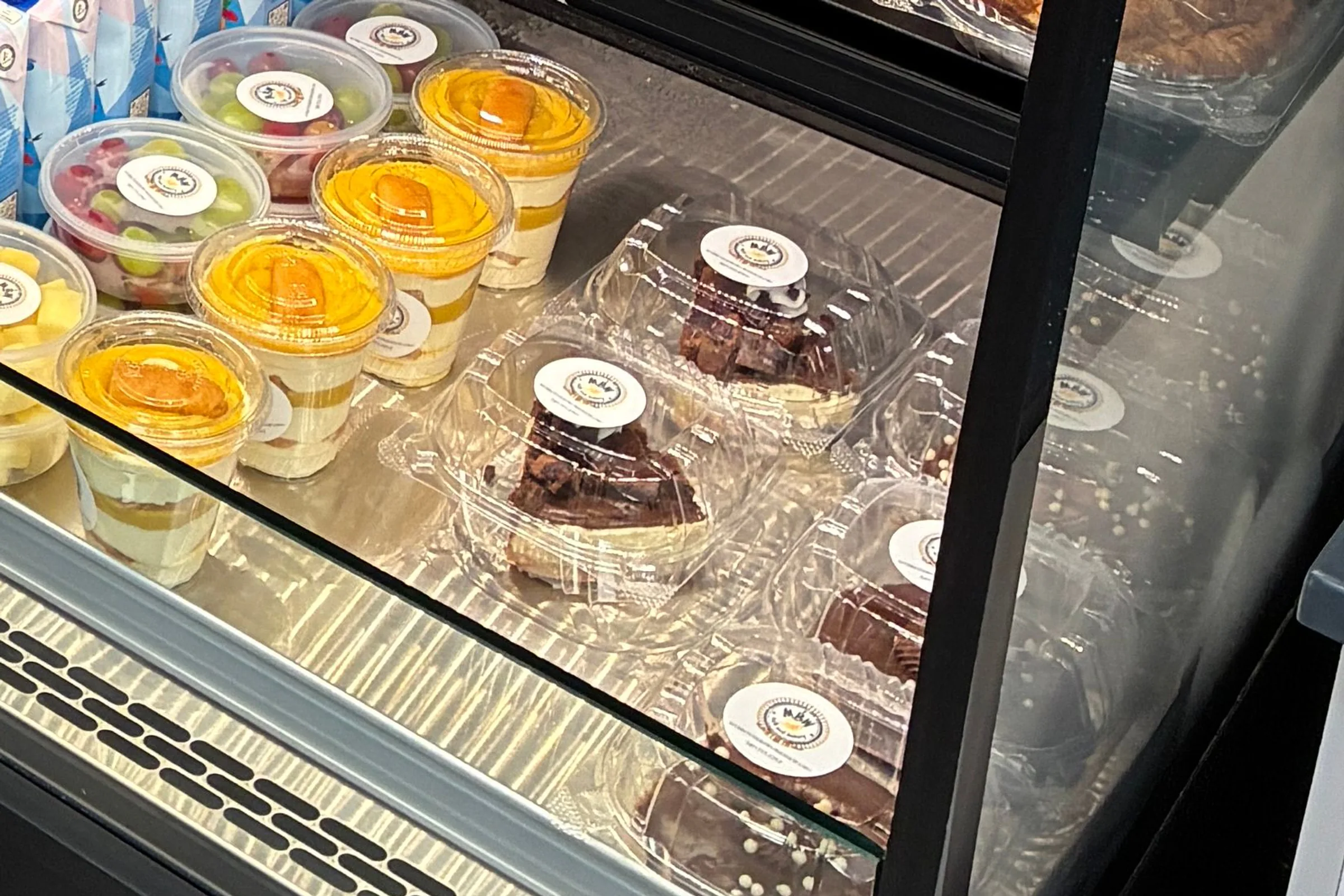 Packaged fruit, parfaits, baked goods, and the display case at My Brother's Workshop Cafe & Bakery.