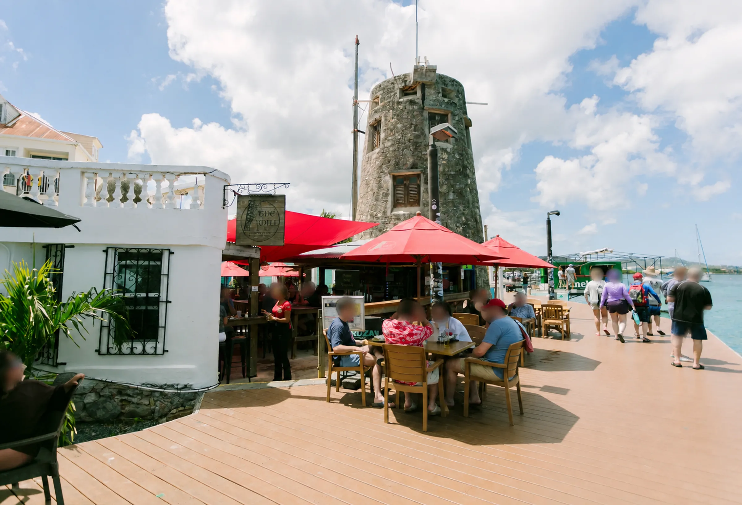 The Mill's waterfront dining area beside the historic mill tower on the Christiansted boardwalk.